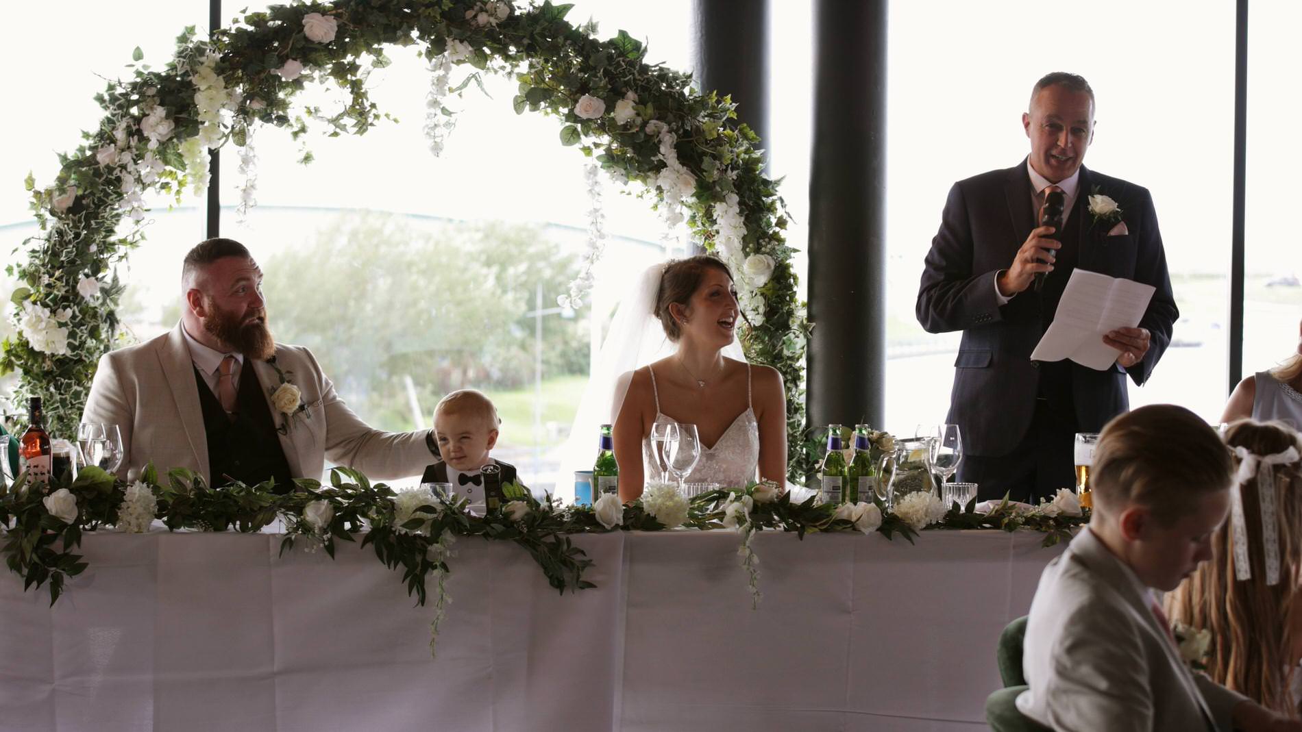 the bride laughs at her Dad during his speech at The Waterfront Southport