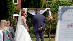 couple laugh during outdoor ceremony at Nunsmere hall Cheshire