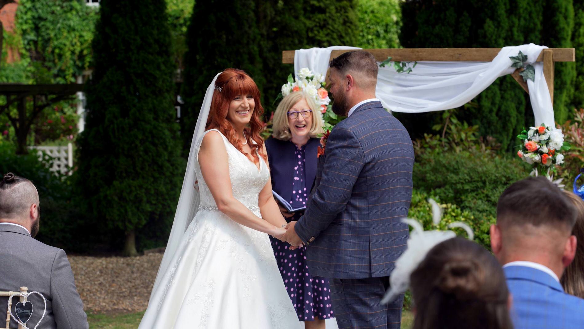 video still of couple laughing during outdoor ceremony at Nunsmere hall