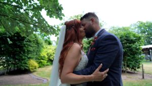 a couple kiss for the videographer at Nunsmere hall