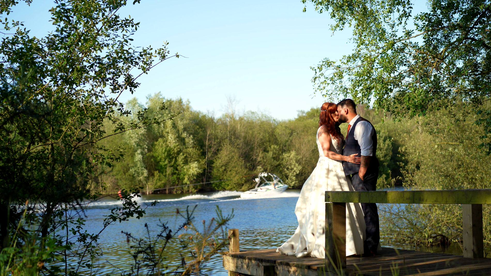 a video still of a newlywed couple by the lake at Nunsmere hall