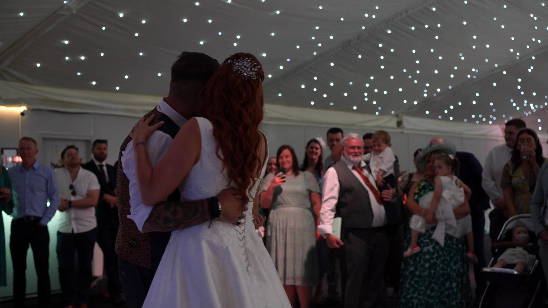a romantic first dance with guests smiling at Nunsmere hall