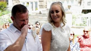 the couple laugh during a vow renewal outdoor ceremony at west tower