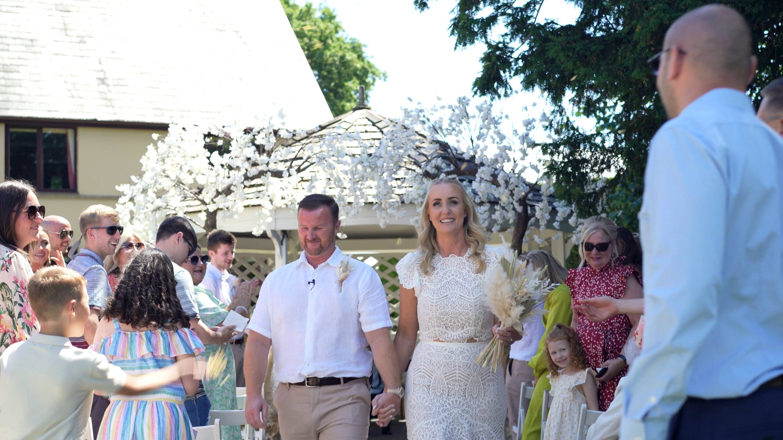 guests throw confetti at the couple after their 10 year vow renewal