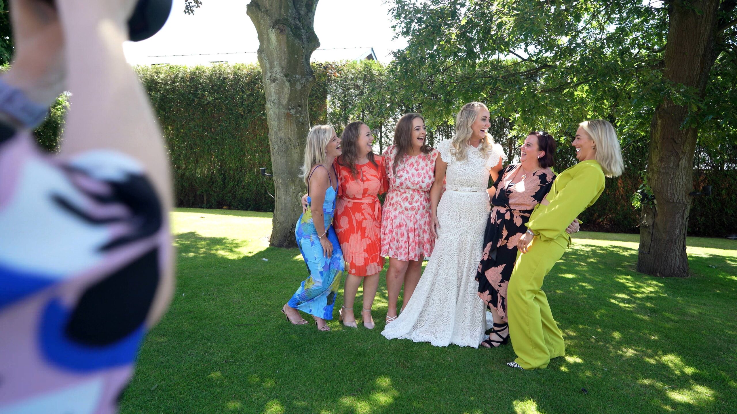 the bride laughs with her sisters for a photo at west tower