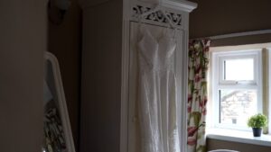 wedding dress hanging in a cottage at Browsholme Hall