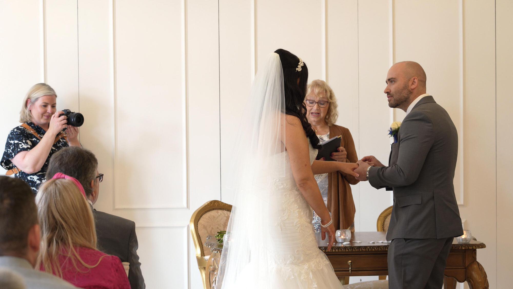 Nicola and Dans West Tower Wedding Video 14 the groom slides on the brides wedding ring