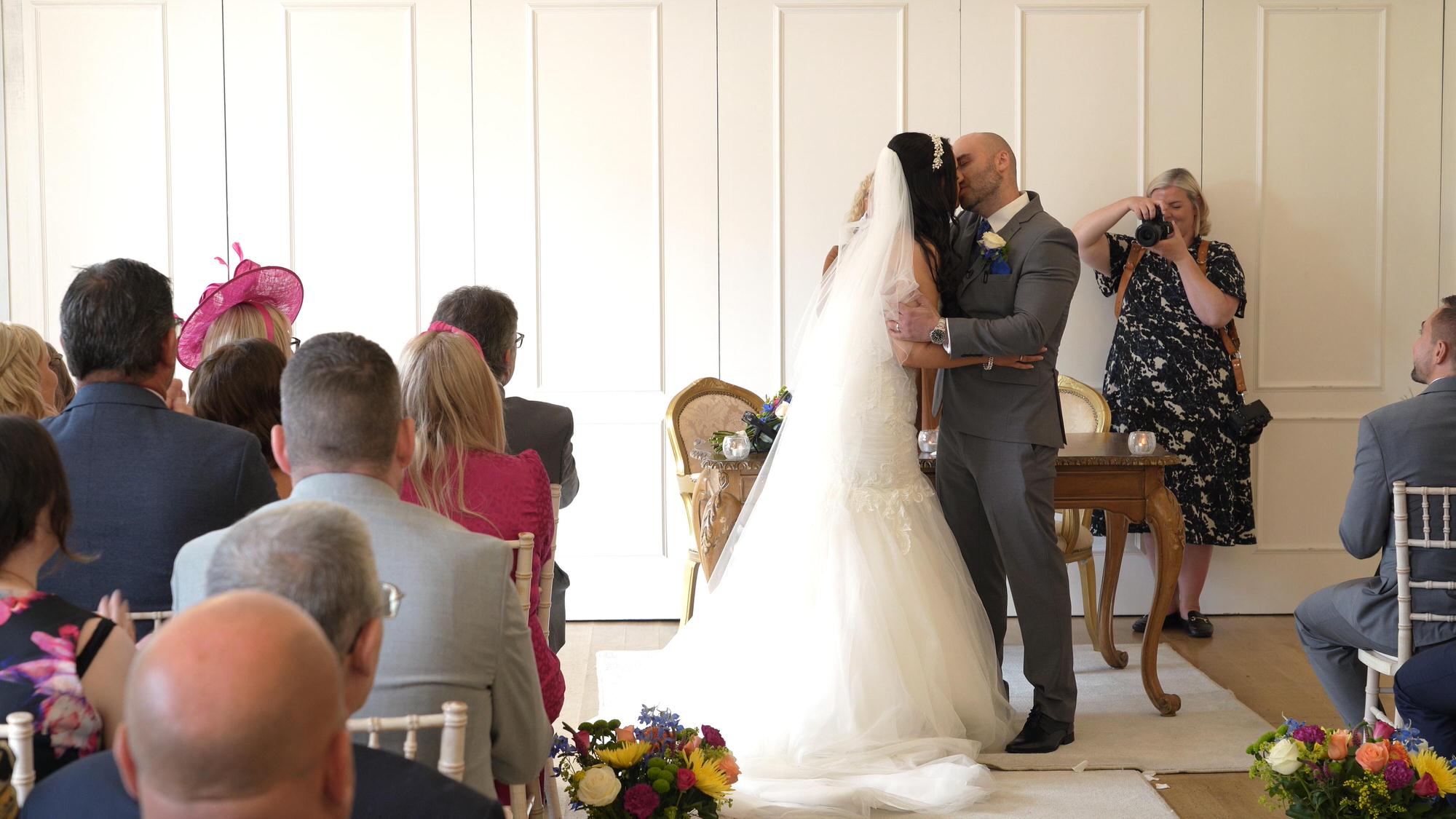 a couple kiss during their indoor West Tower wedding