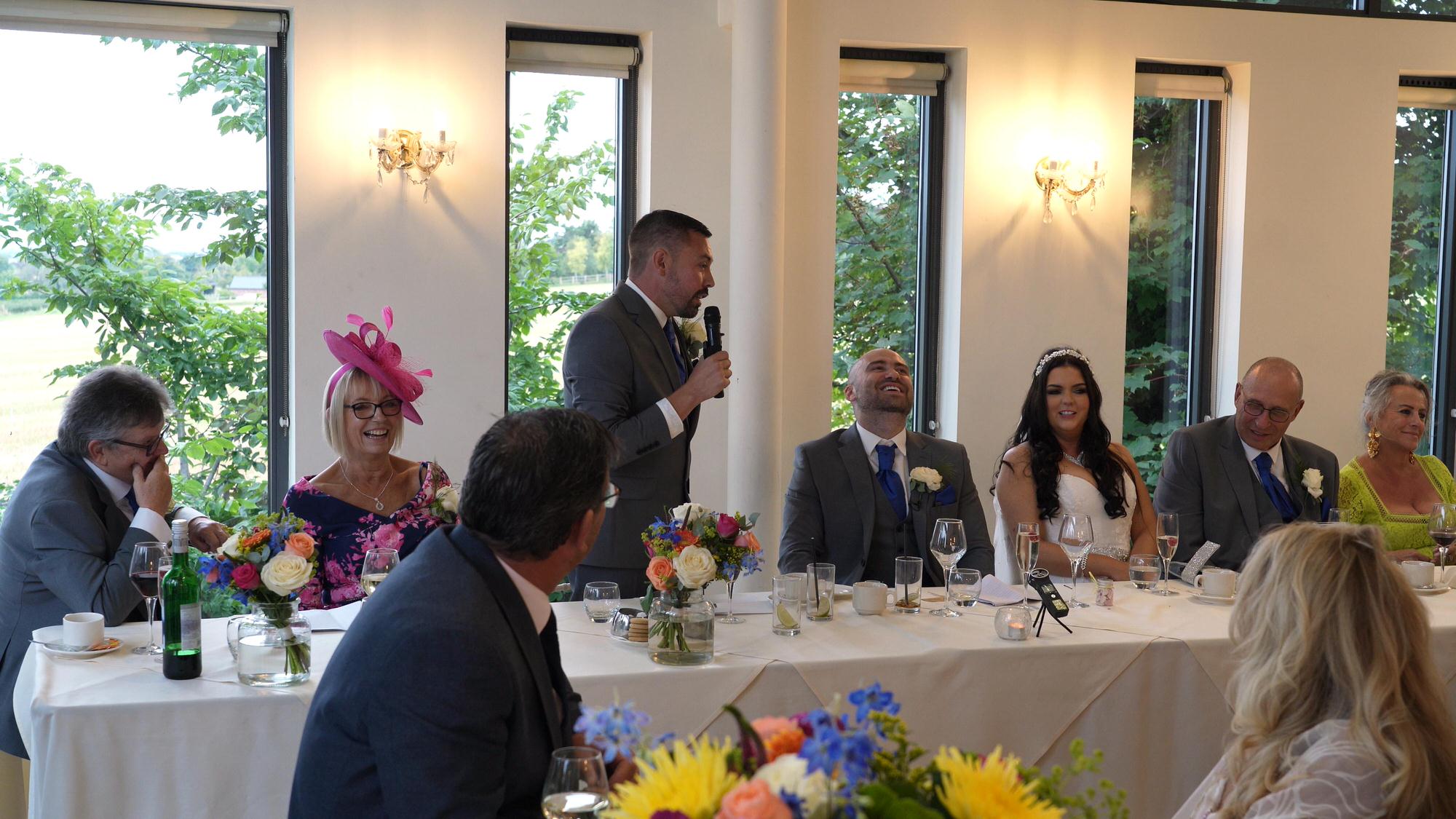 a best man makes the groom laugh during his speech