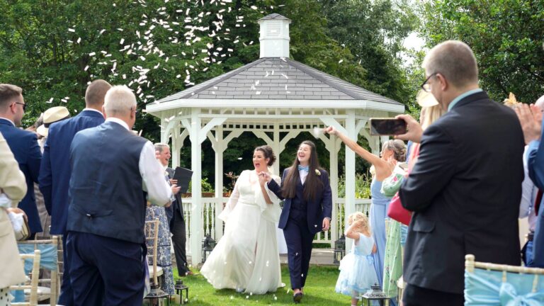 a happy couple walk back down the aisle at The Aviary in Ormskirk