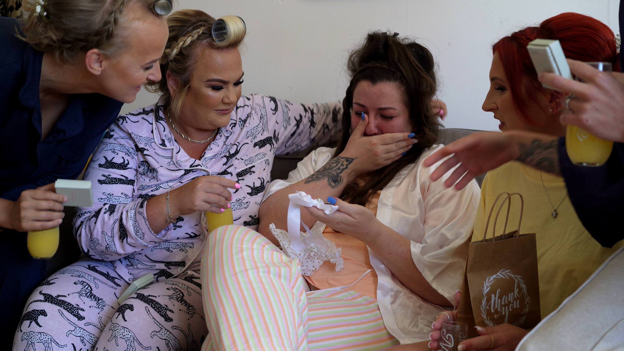 a bride gets overwhelmed by her bridesmaids gift