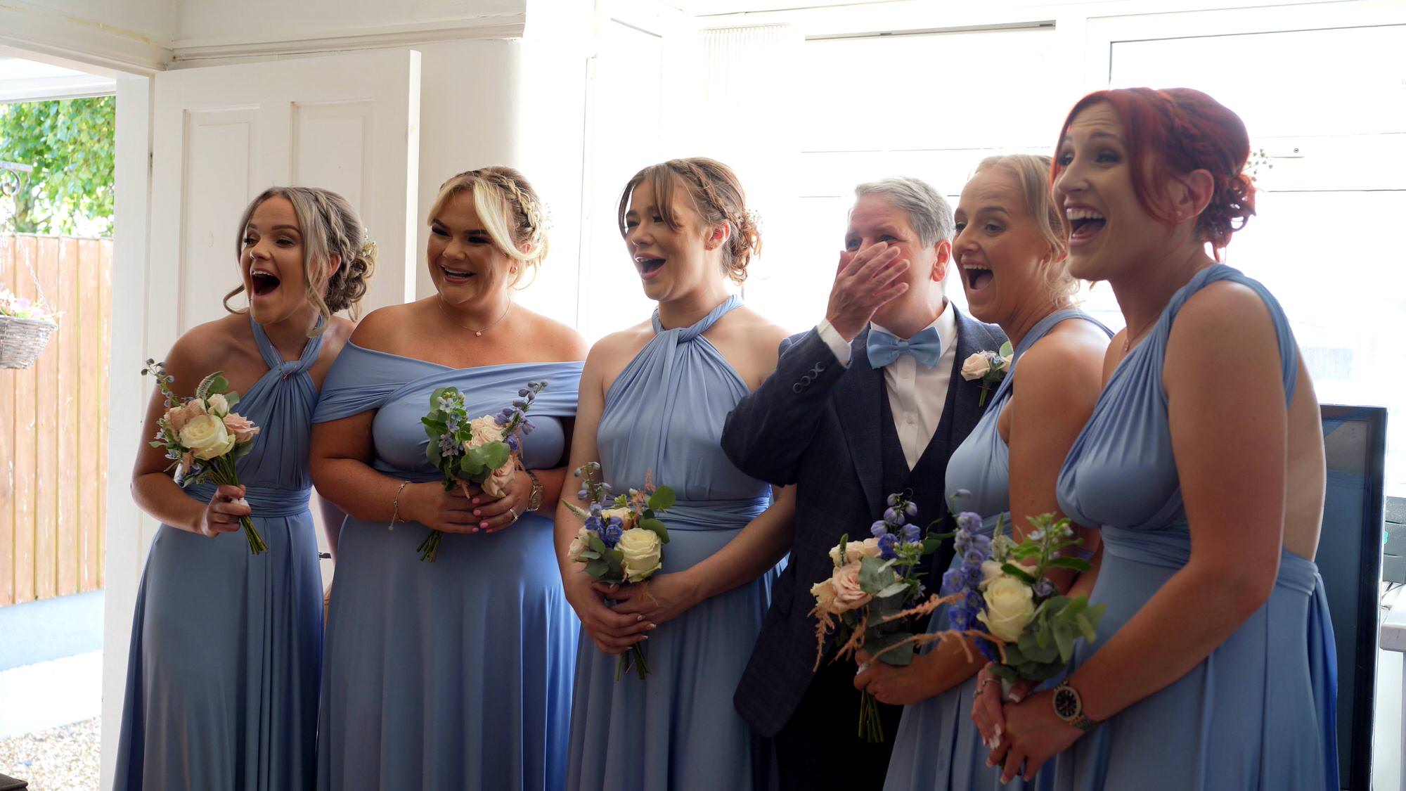 a videographer captures the reaction of the bridesmaids seeing the bride for the first time