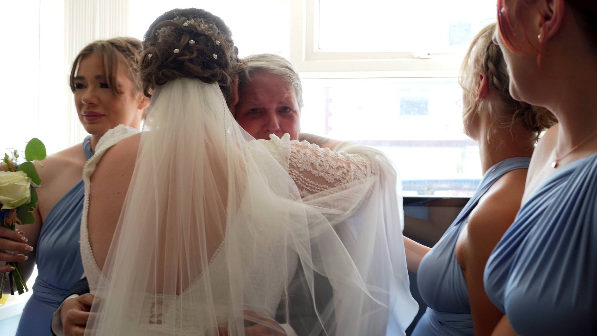 the bride hugs her emotional stepmum