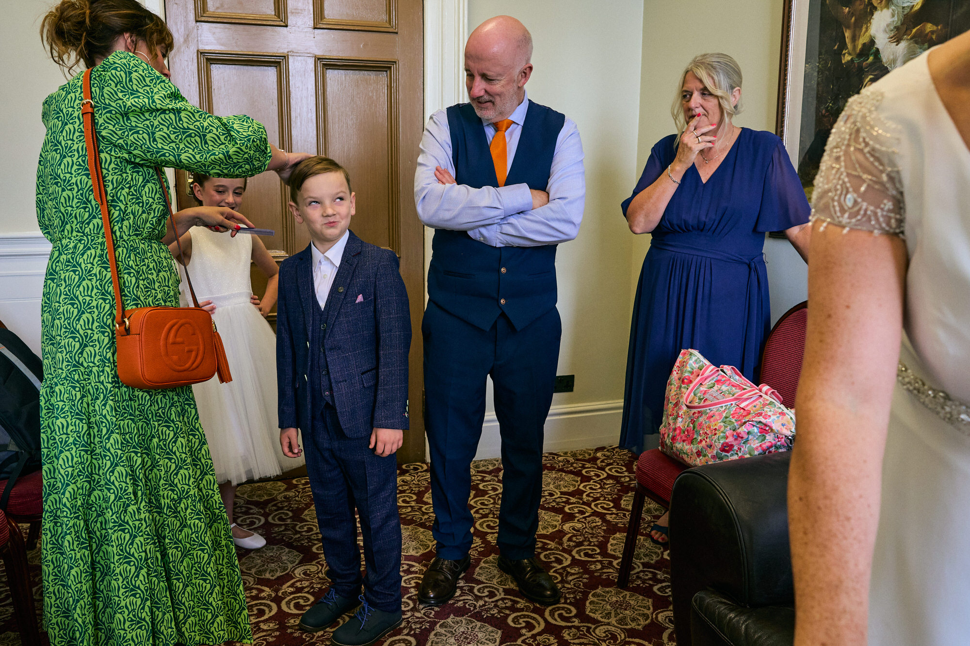 guests tease a page boy before the wedding ceremony at St Georges Hall in Liverpool