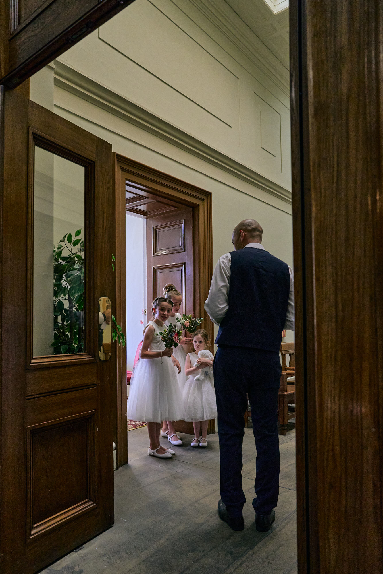 a natural photo of flower girls in the corridor outside the Jury Room at St Georges Hall in Liverpool