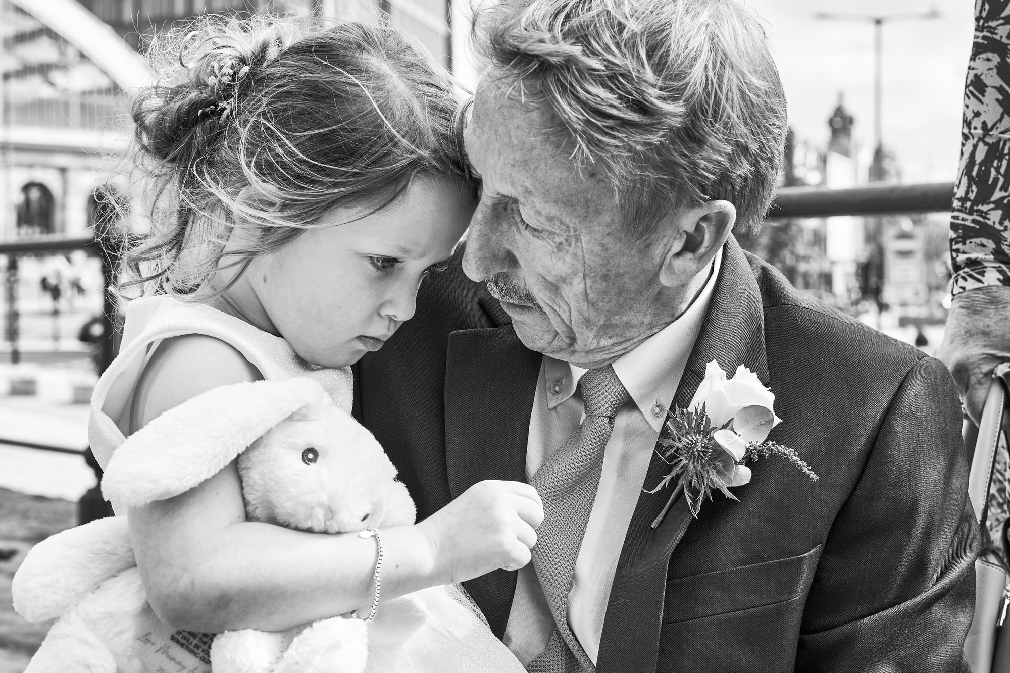 a candid moment with Grandad and a flower girl in Liverpool