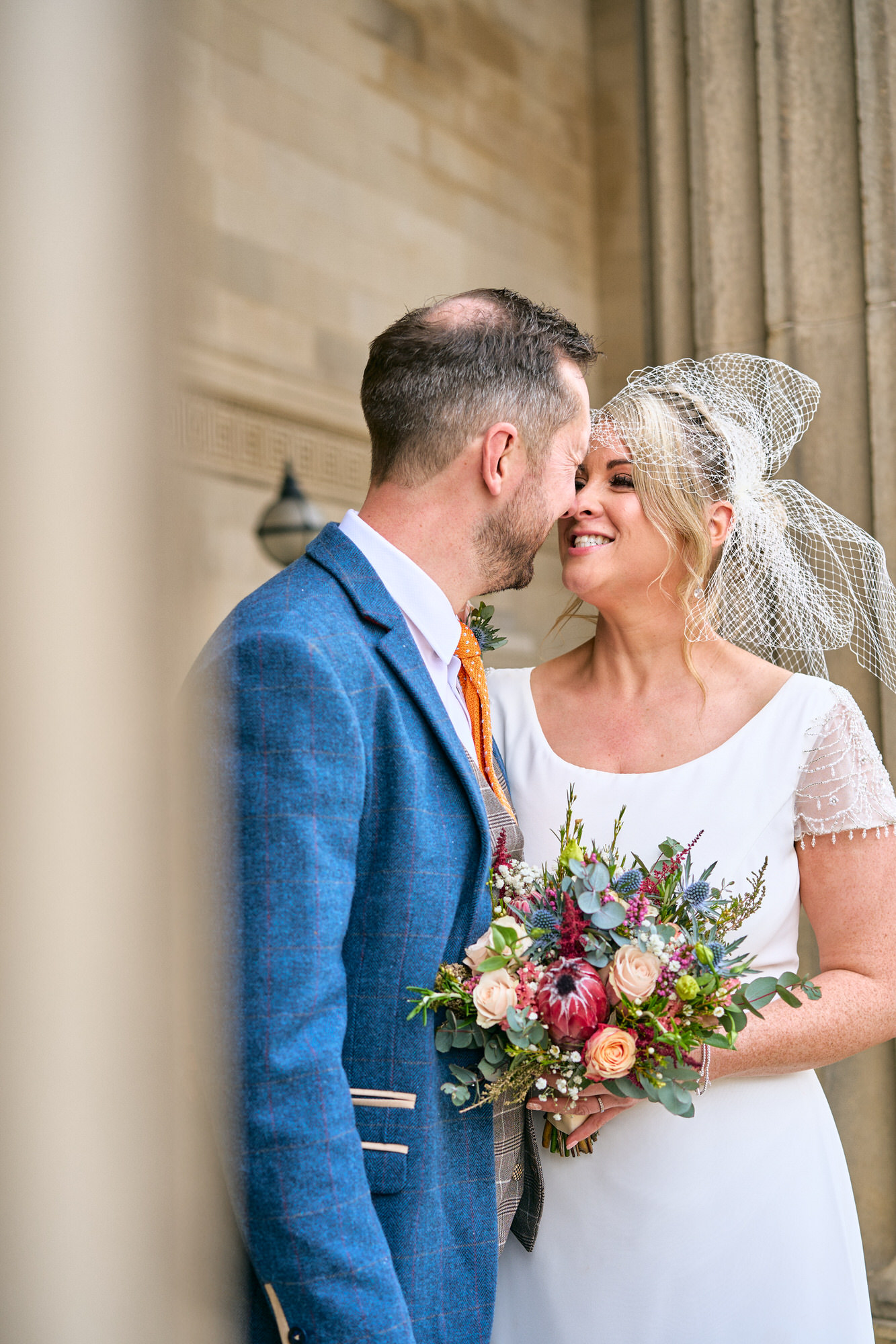 a relaxed photo of newlyweds outside St Georges Hall Liverpool