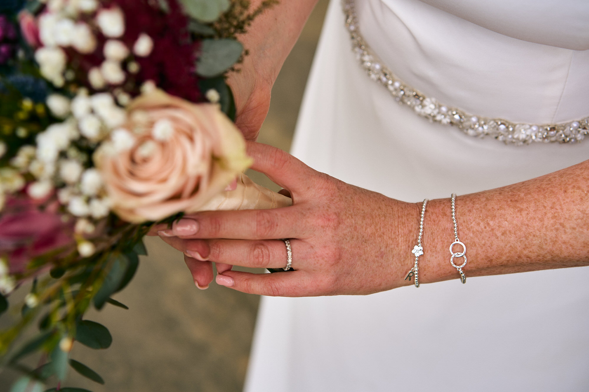 a close up photo of the brides personalised wedding bracelet