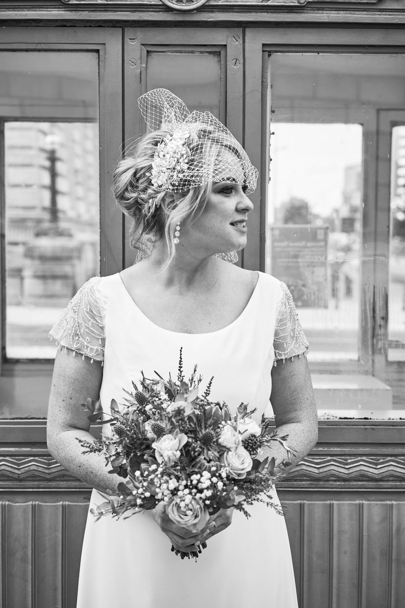 a relaxed portrait of a bride holding her bouquet by Mann Island