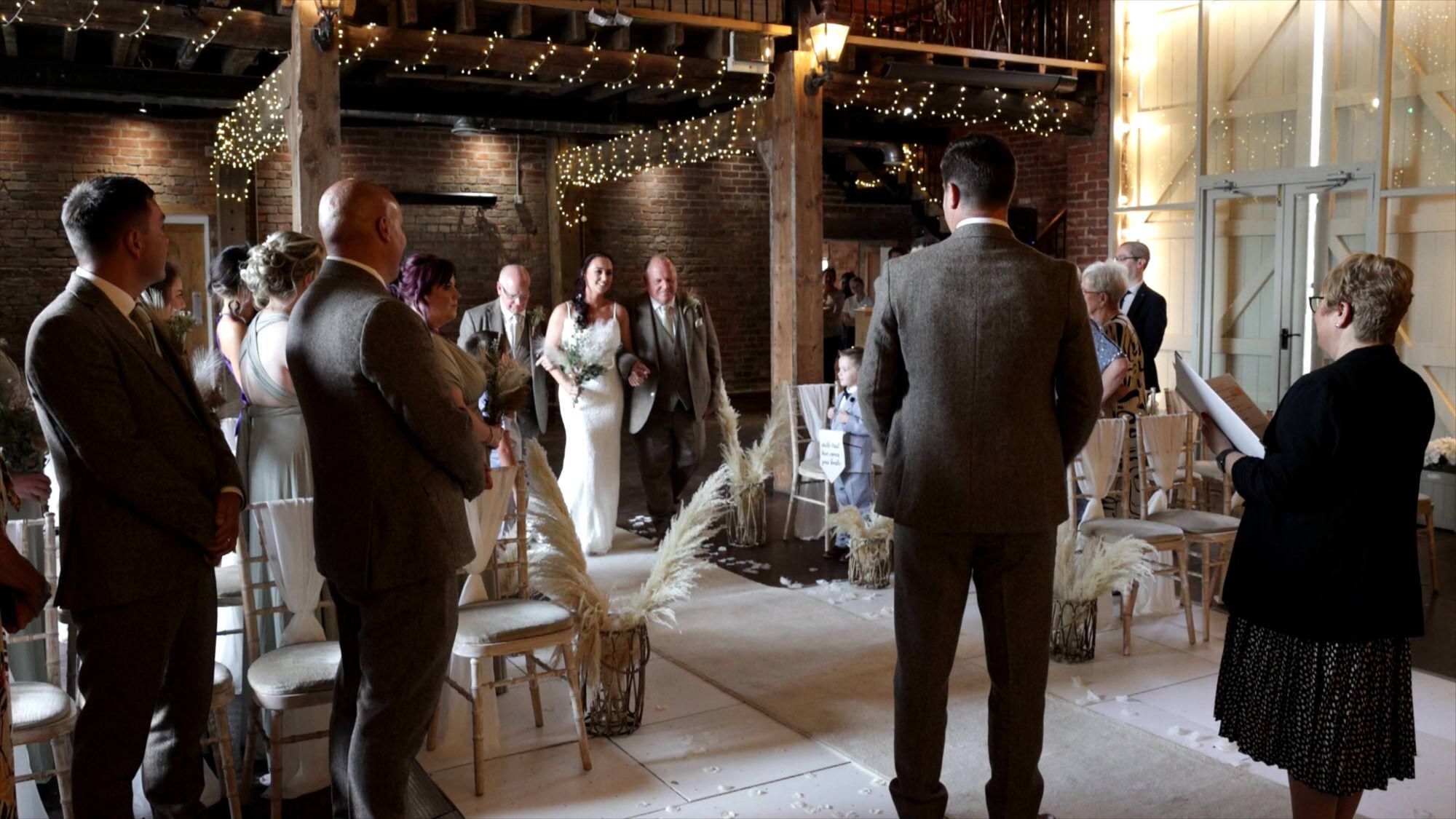 bride walks down the aisle at the barn at morleys hall manchester