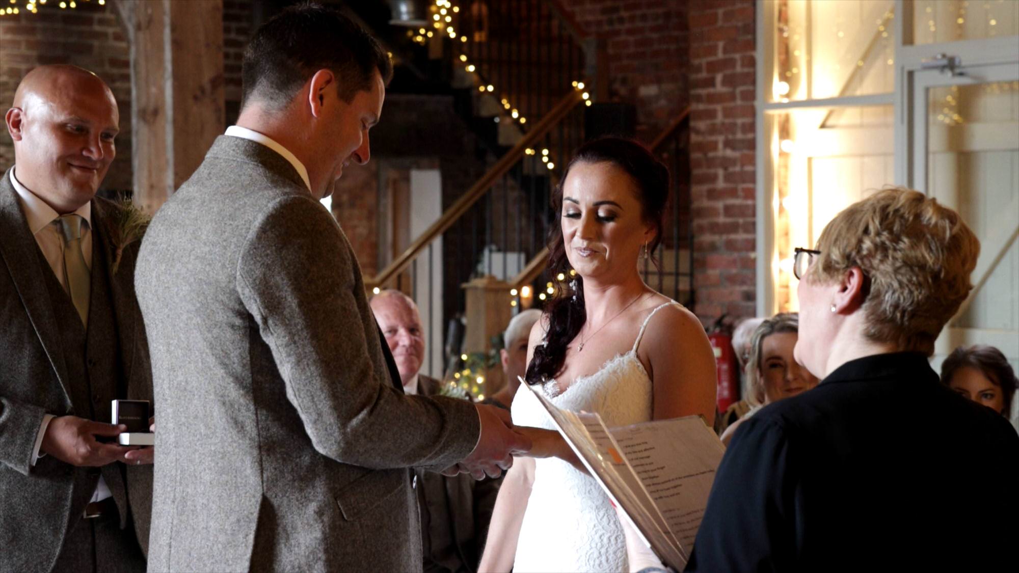 the couple exchange wedding rings at the barn at morleys hall