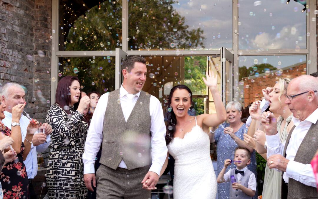 video still of a couple dancing down an aisle of bubbles outside the barn at morleys hall