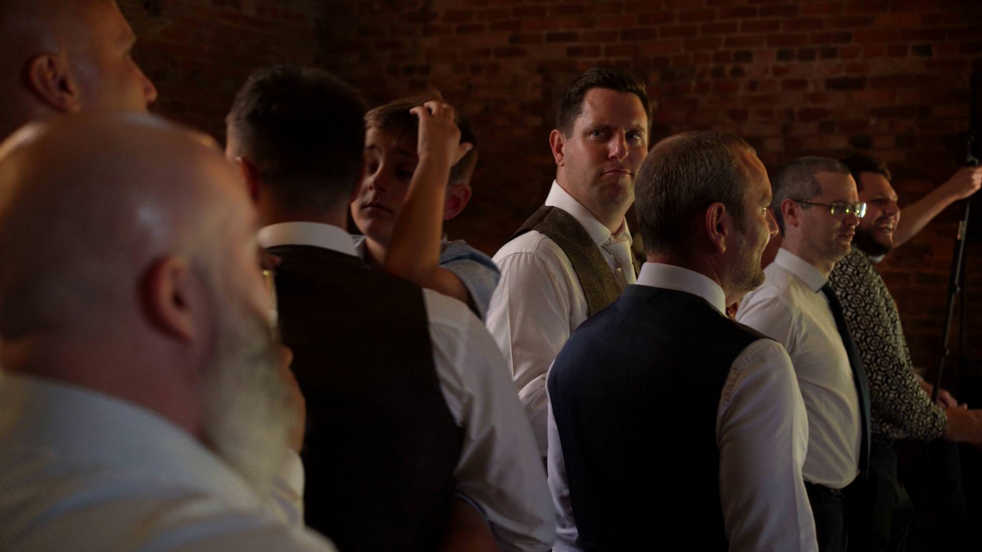 videographer captures a funny face from the groom during dancing