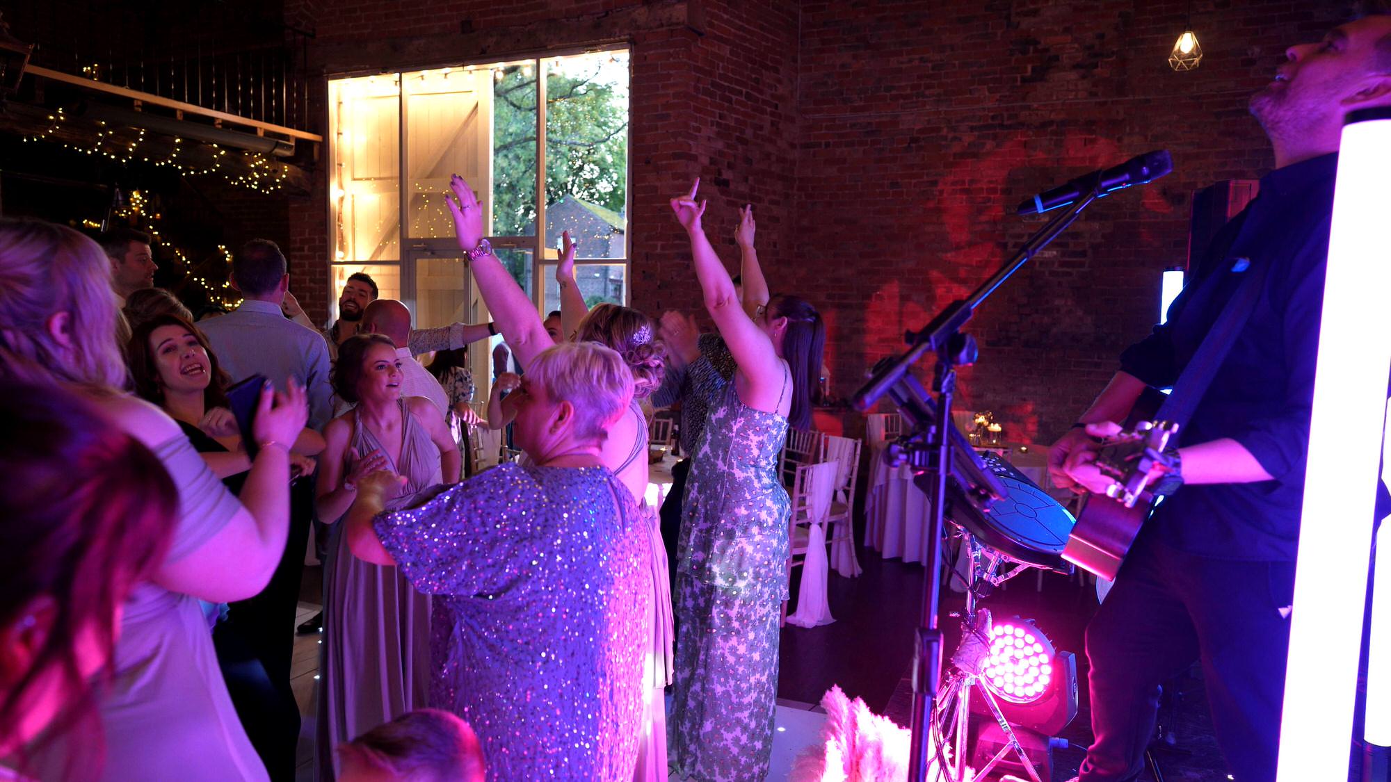 alex birtwell wedding singer sings to a full dancefloor at the barn at morleys hall