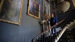a video still of the bride and grandad walking her down the stairs at Stubton Hall Newark