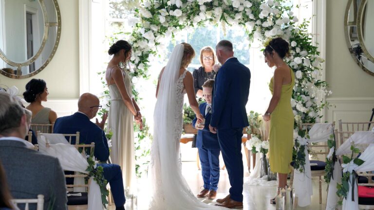 a page boy gives the wedding ring to the bride during the ceremony