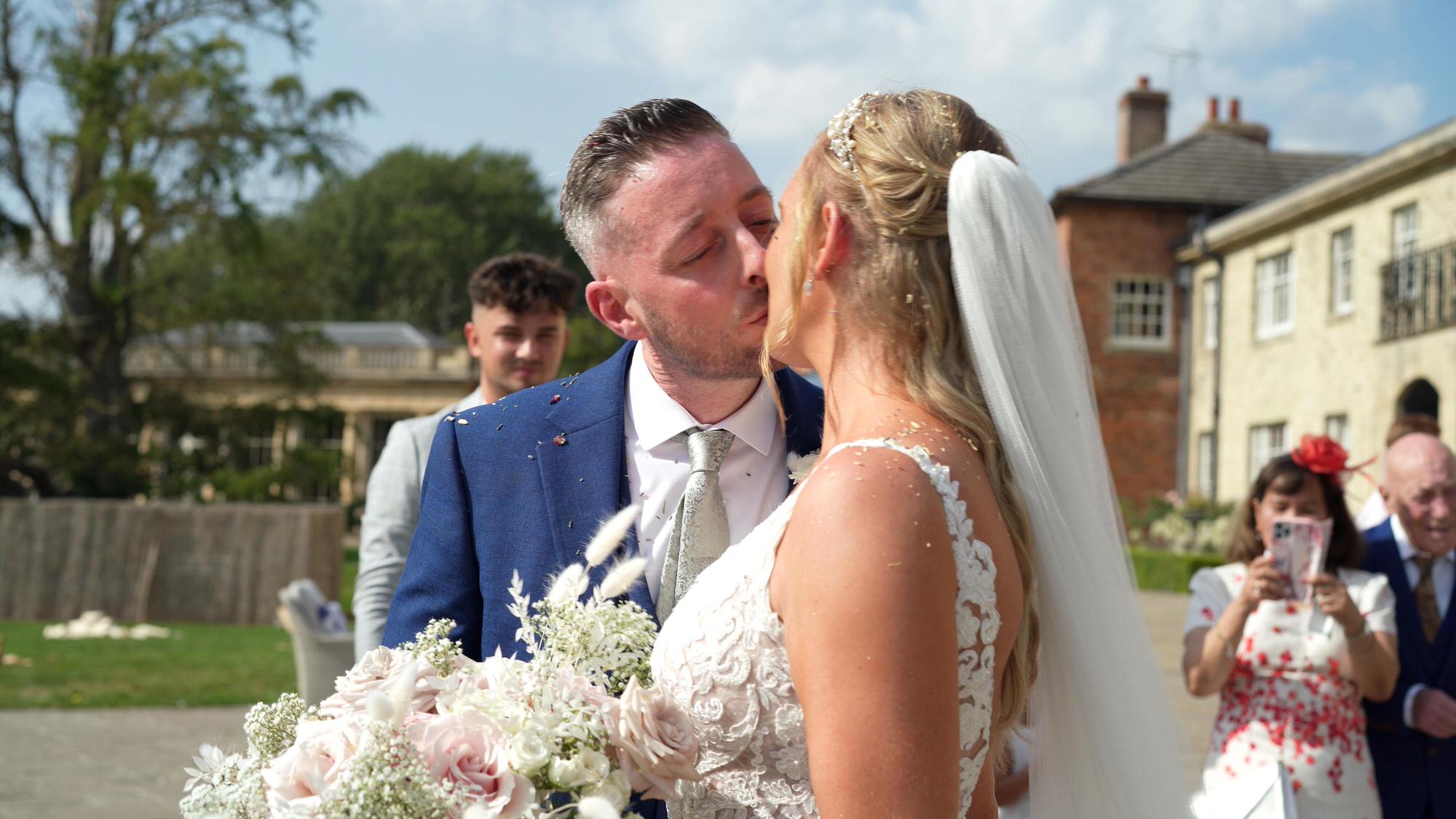 a bride and groom kiss on the terrace at Stubton Hall Newark
