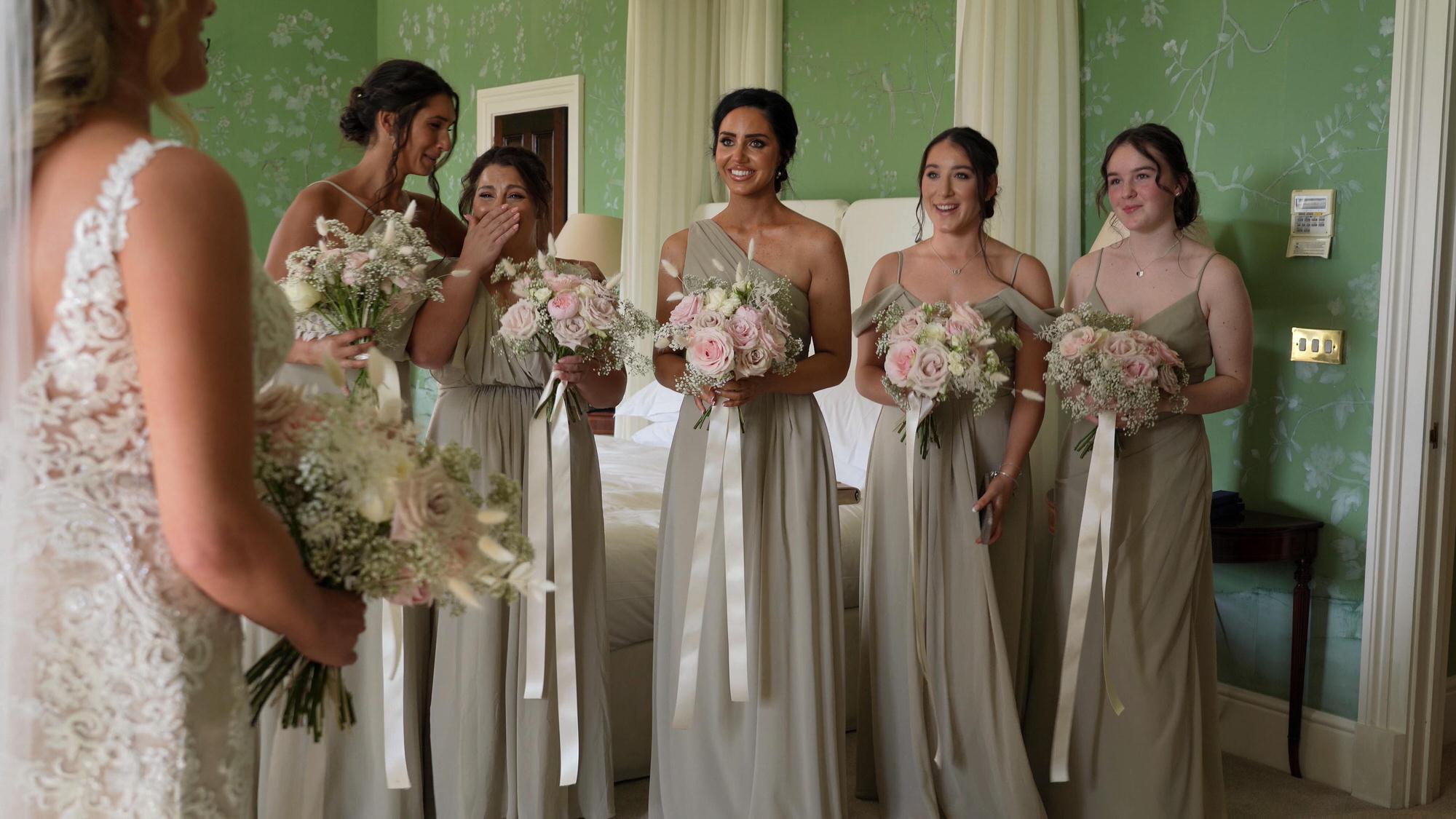 a videographer captures the bridesmaids first look of the bride at Stubton Hall Newark