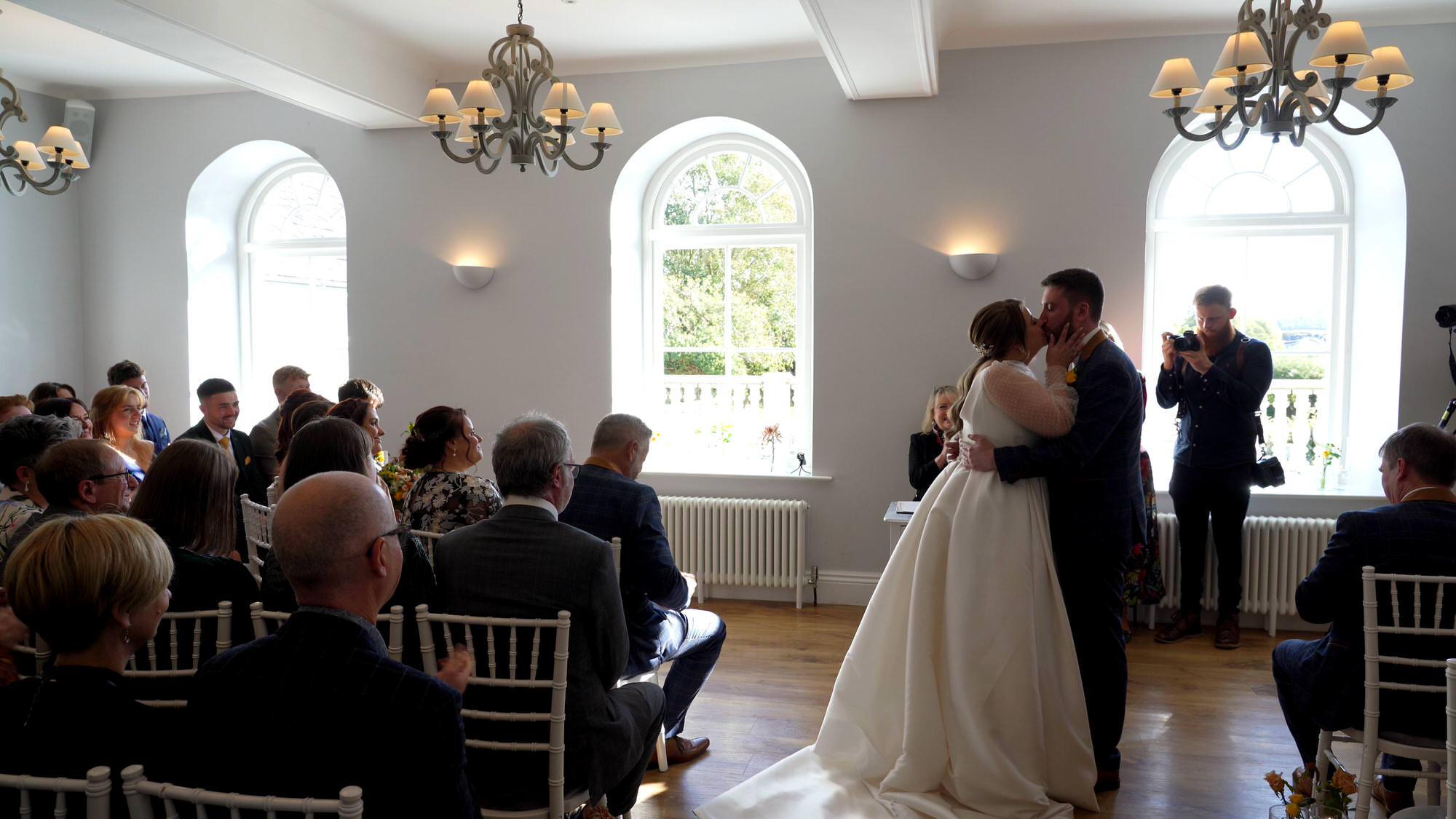 the couple kiss at the end of their lake district wedding ceremony