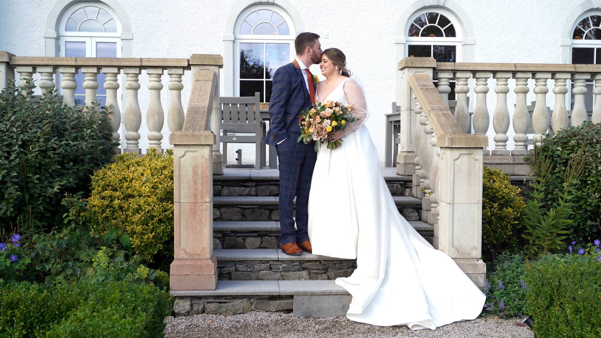 a relaxed portrait of a wedding couple on the stairs
