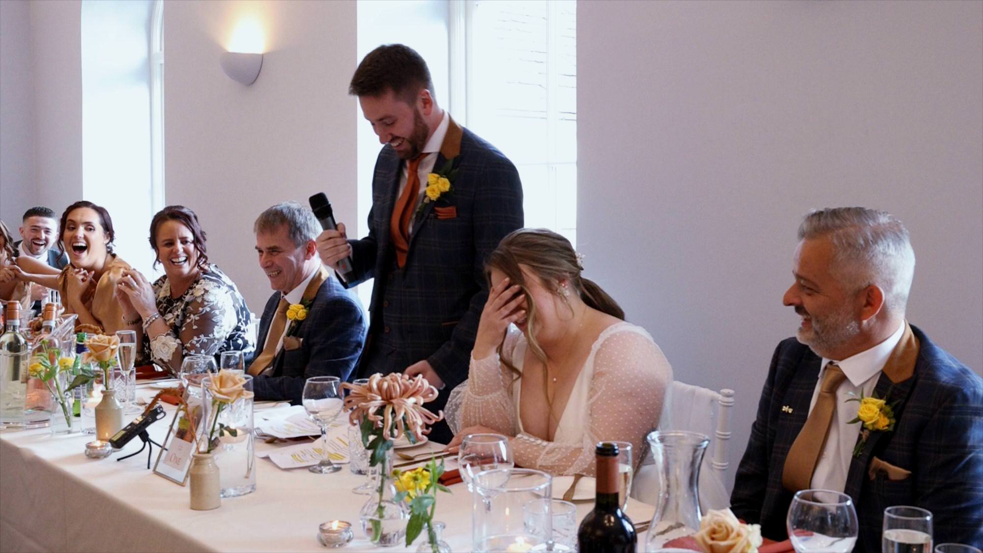 the groom makes his bride laugh during his wedding speech