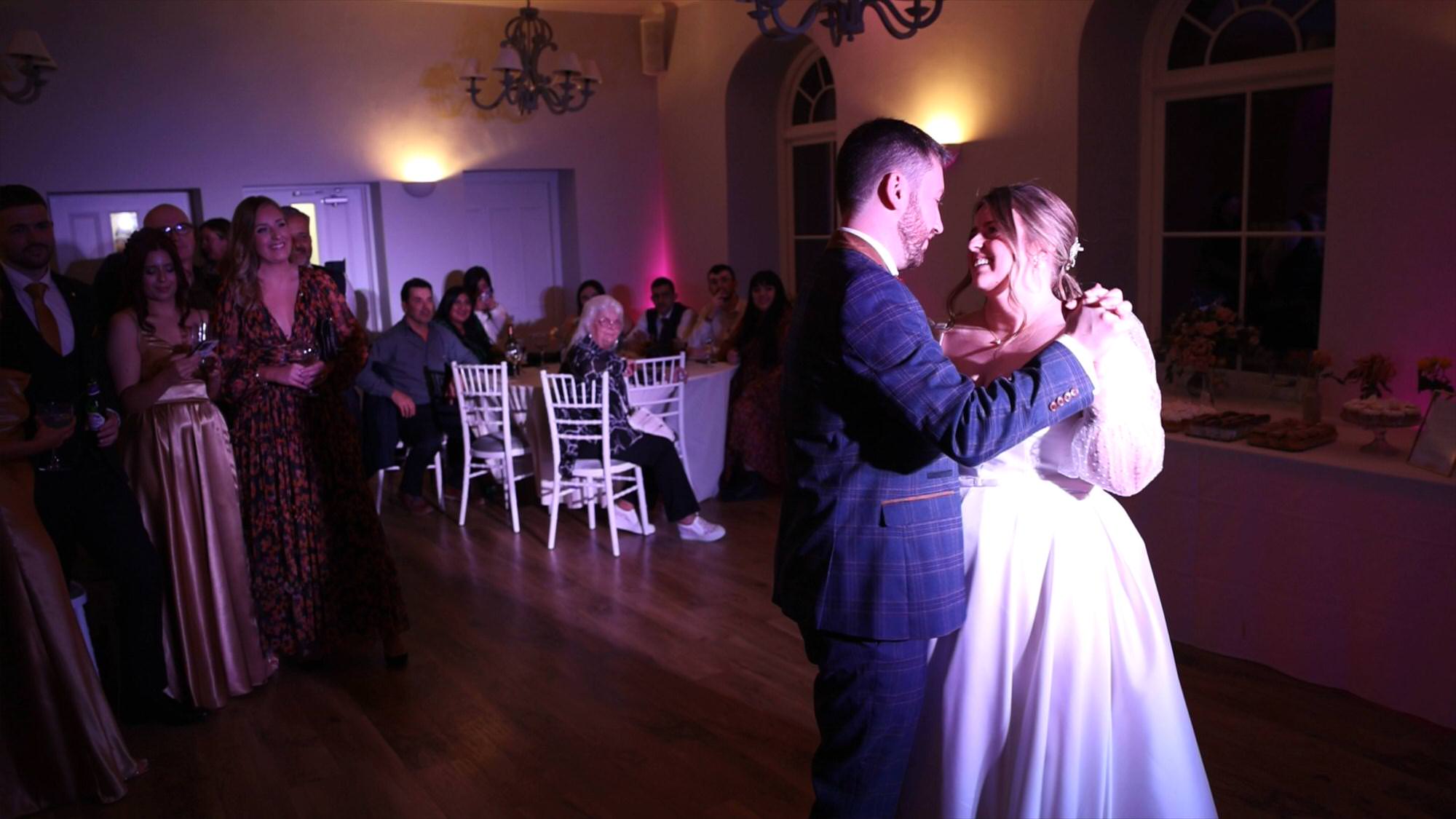 a couple enjoy their slow first dance during their Cartmel Old Grammar wedding