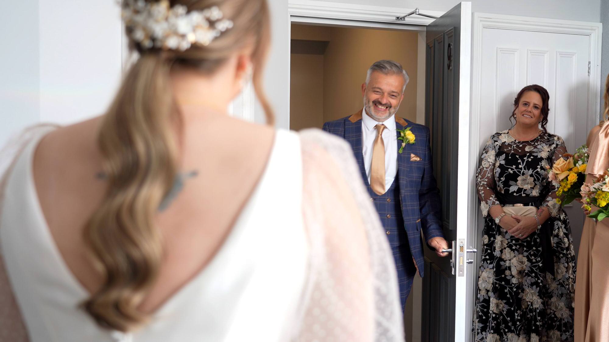 a father of the brides first look captured by the wedding videographer