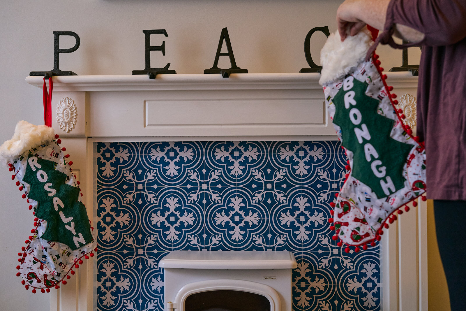 Family Christmas Eve Photography Lancashire 4 a parent goes to hang the christmas stockings by the fire