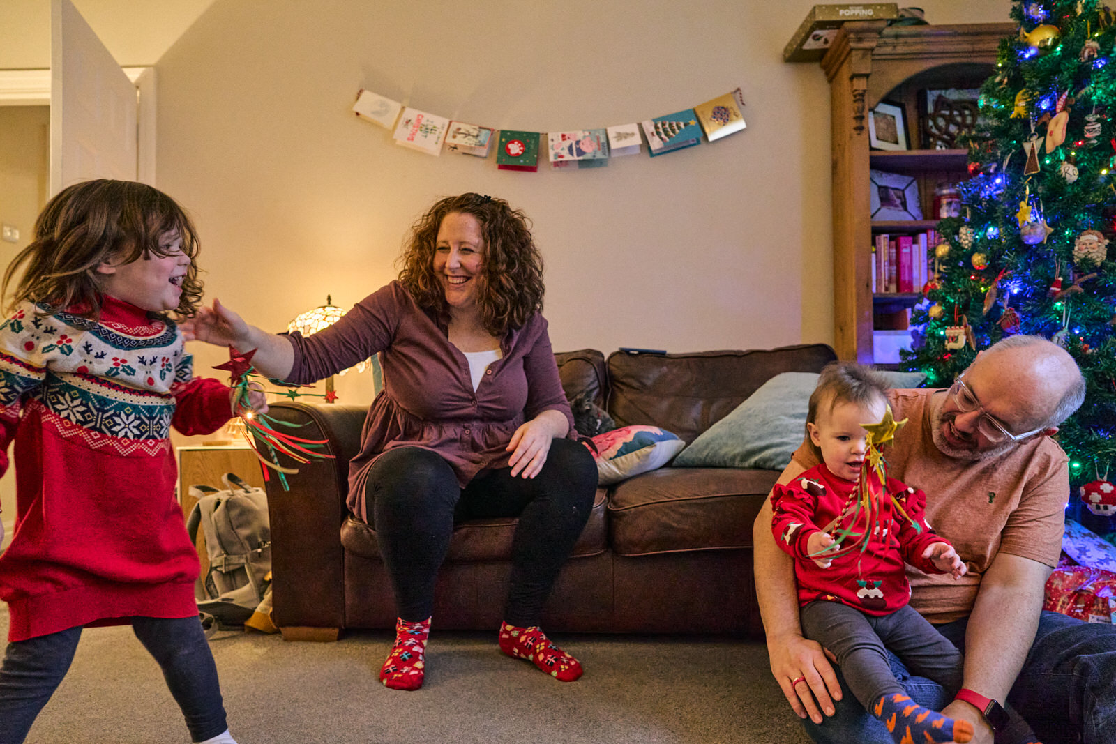 a natural family photo from their living room at Christmas in Ramsbottom