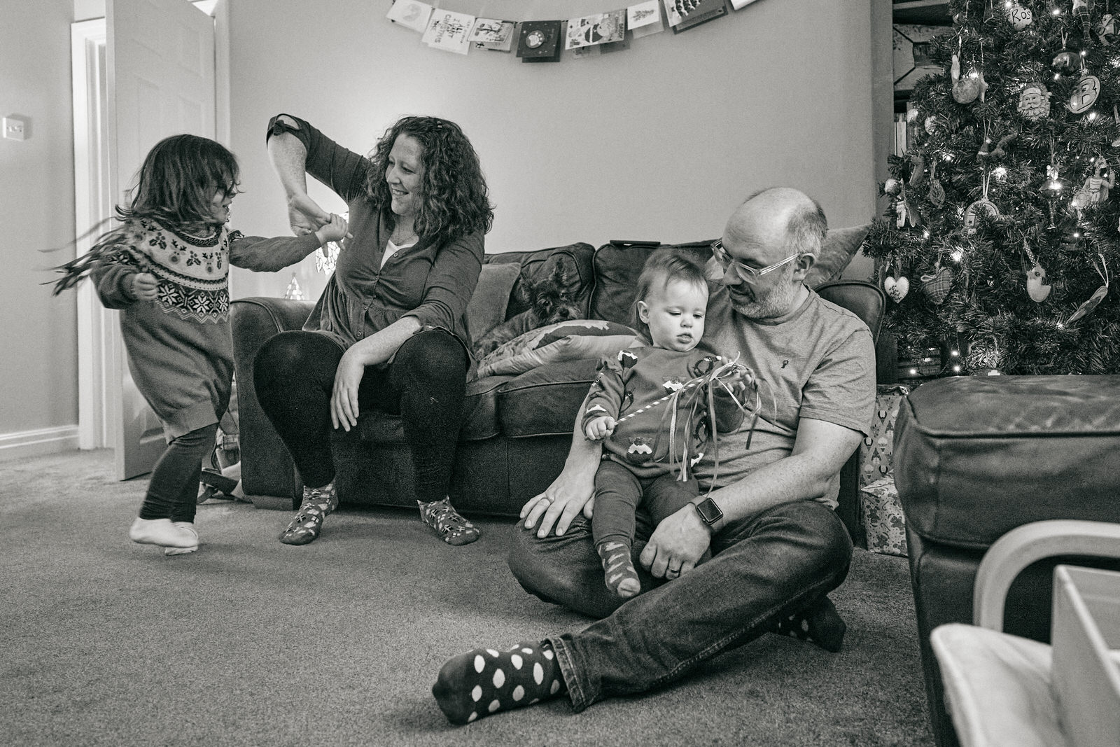 a family hang out at home on Christmas eve with a family photographer