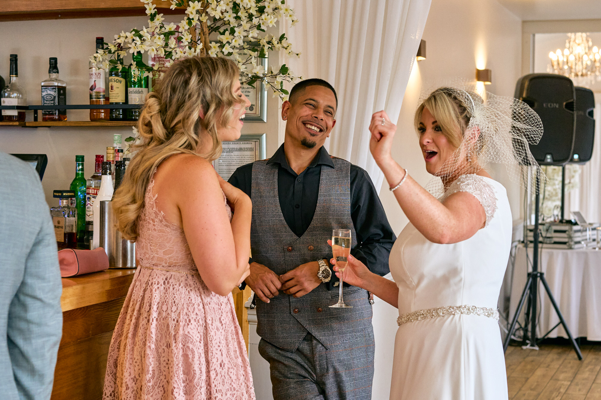the bride chats and laughs with guests at her Aviary wedding
