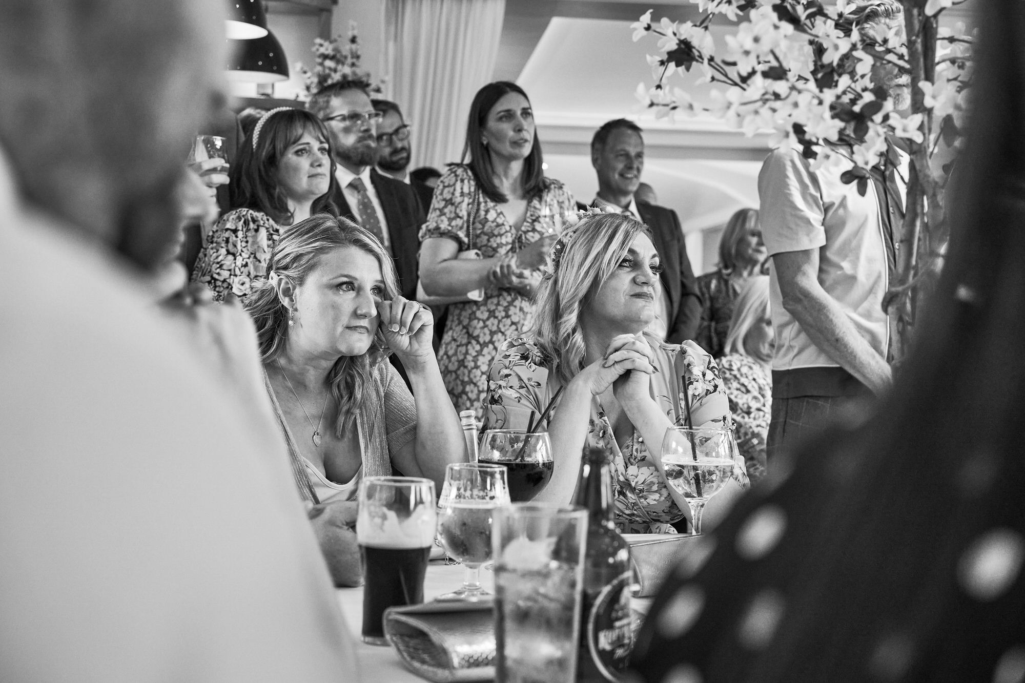 a candid photo of a guest wiping away a tear during the vows at The Aviary Ormskirk