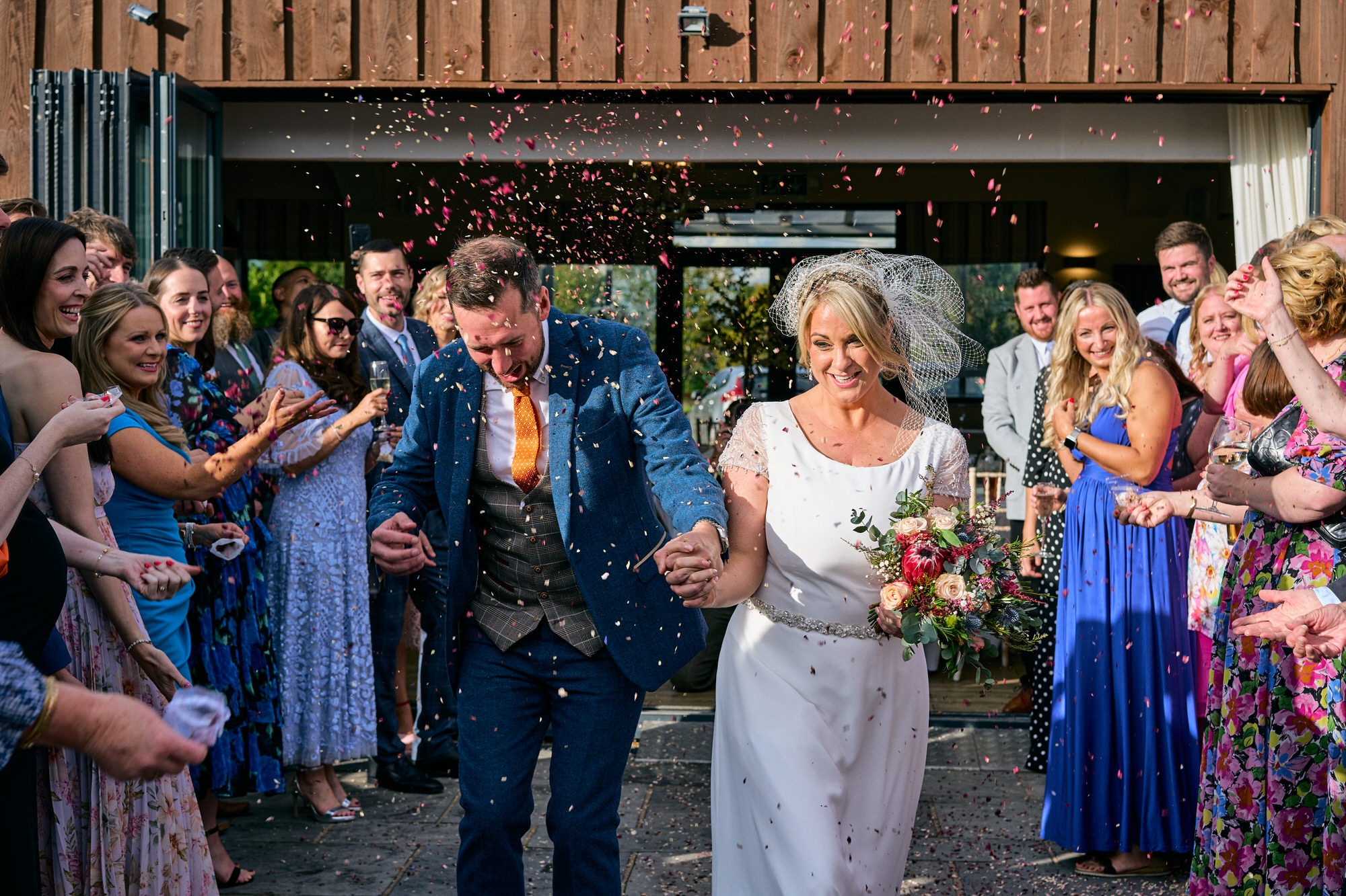 the groom picks confetti out of his mouth in this fun photo