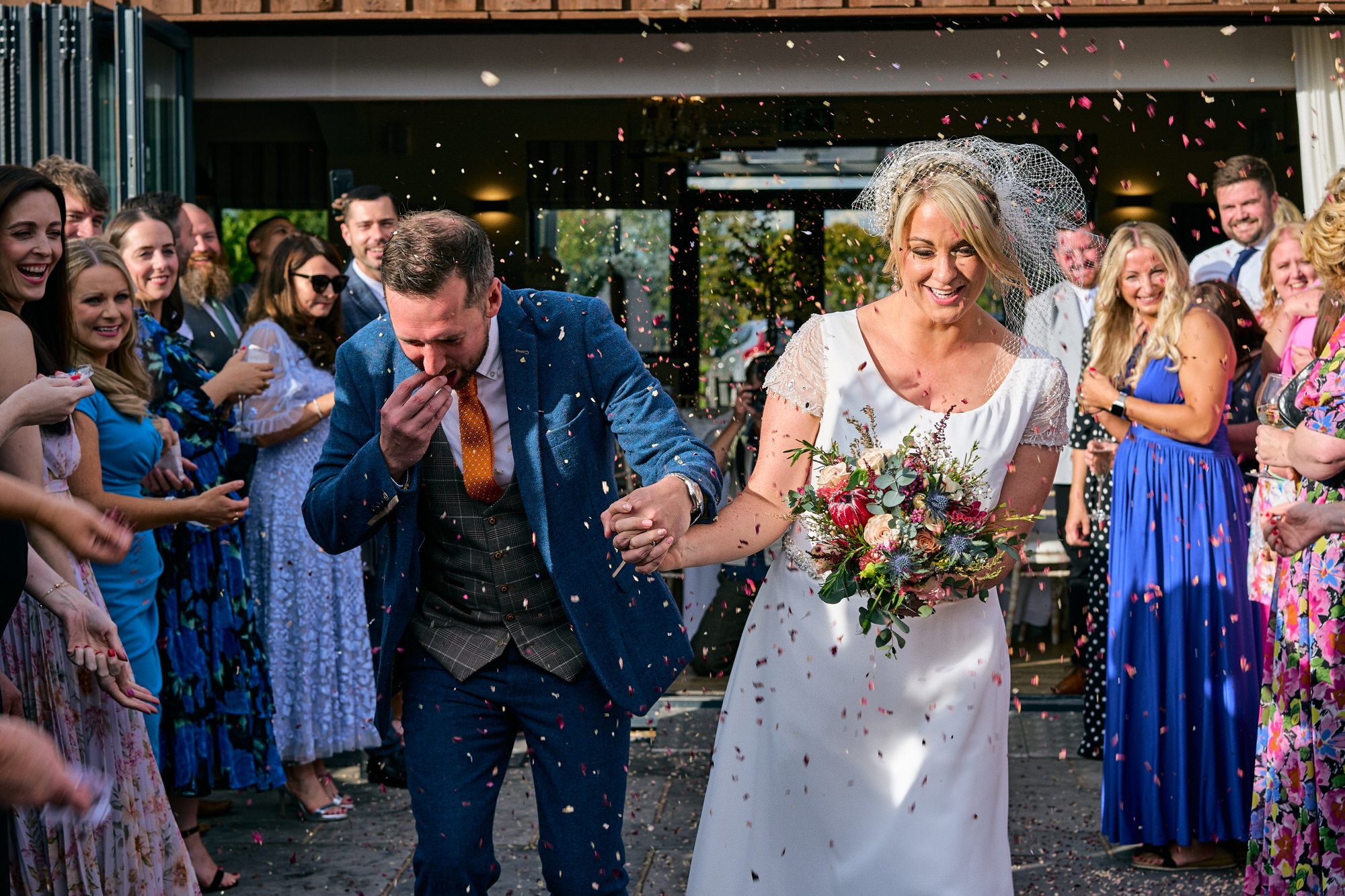 the couple get covered in confetti outside The Aviary Ormskirk
