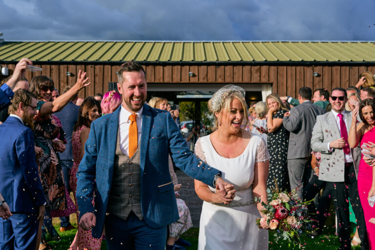 a natural photo of a bride and groom enjoying their confetti shot outside The Aviary Ormskirk