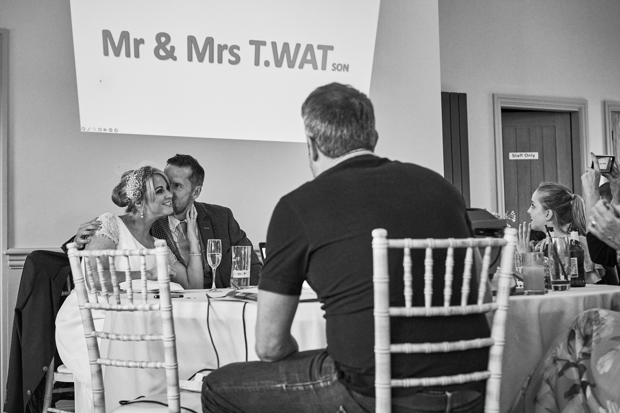 a photo of the couple kissing under a funny joke on the slideshow