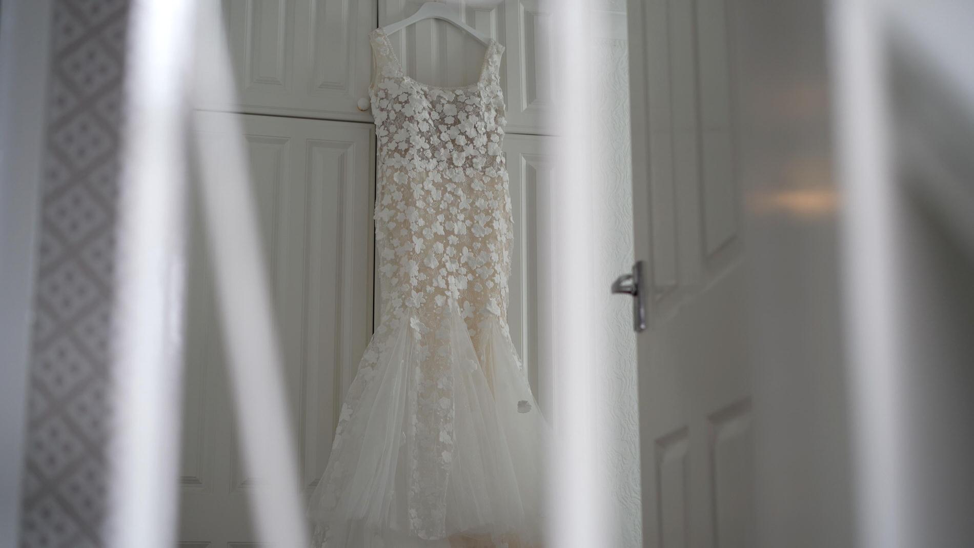 a wedding dress hangs in a home in crossens near churchtown