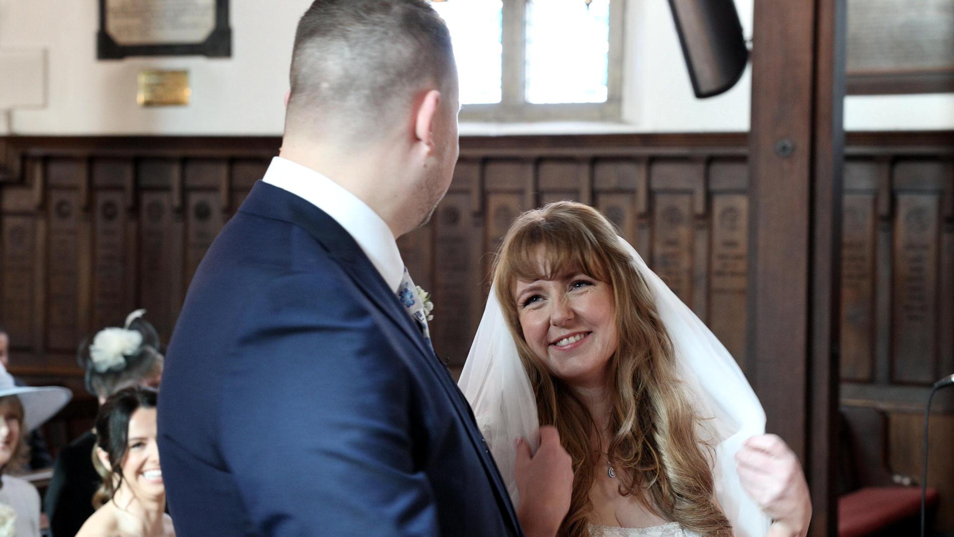 a candid video still of a couple smiling during the wedding ceremony in Churchtown