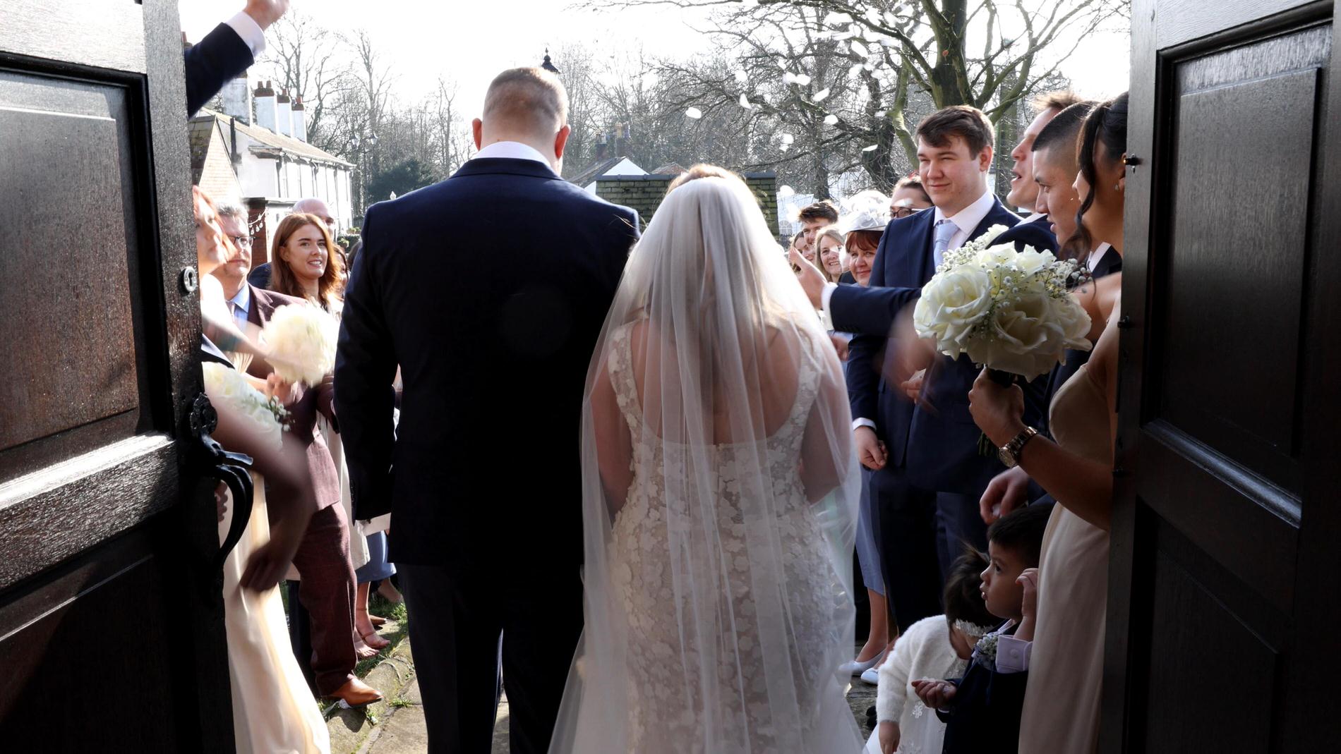guests shower the couple in confetti