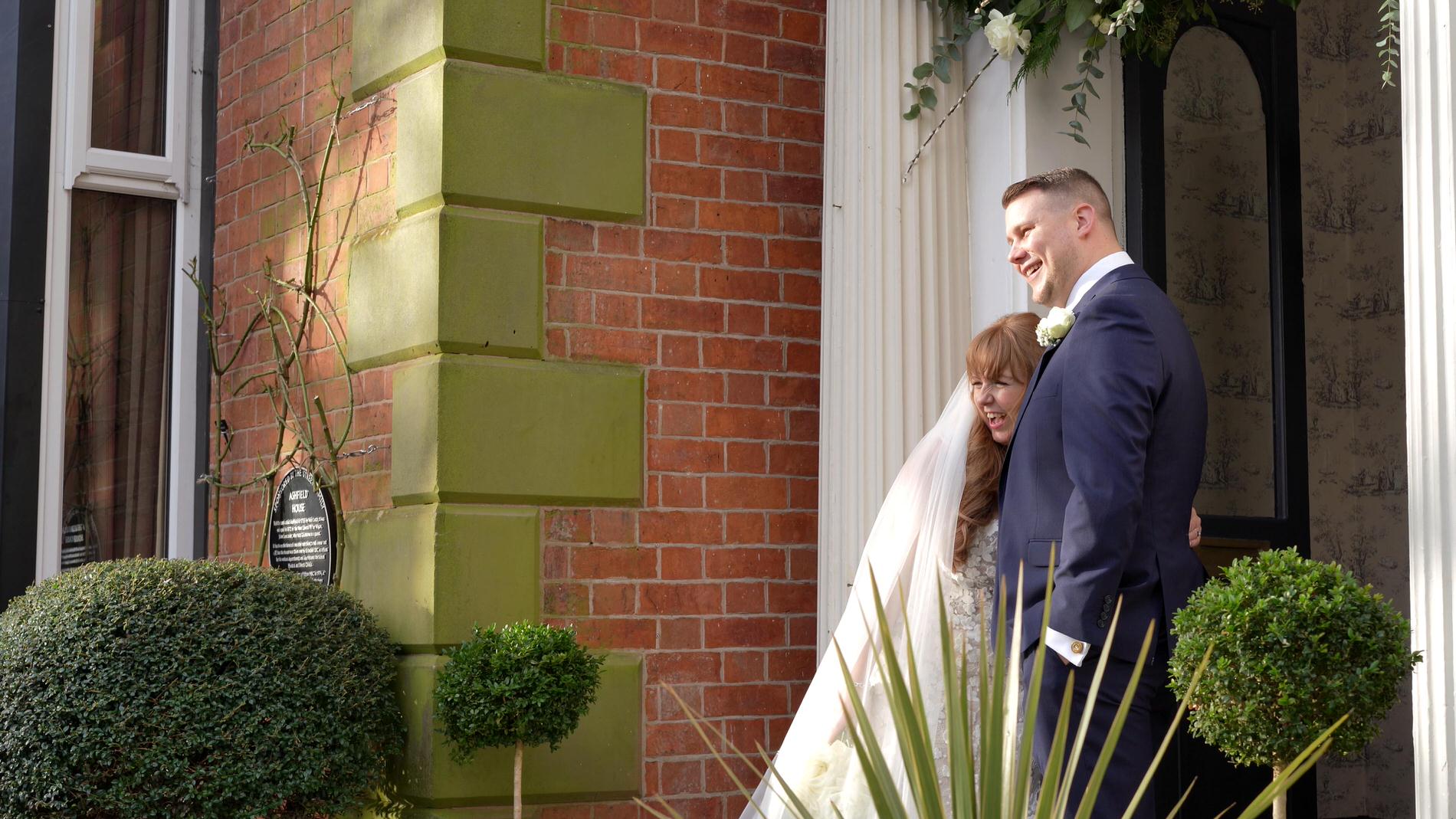 a couple cuddle up in the doorway of Ashfield House Standish